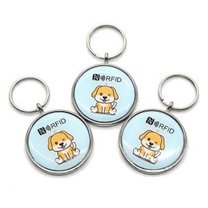 Four round metal frame epoxy pet fobs with cartoon dog designs and keyrings