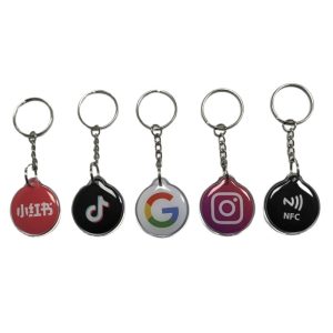 Five round social media NFC epoxy key tags lineup with different platform logos